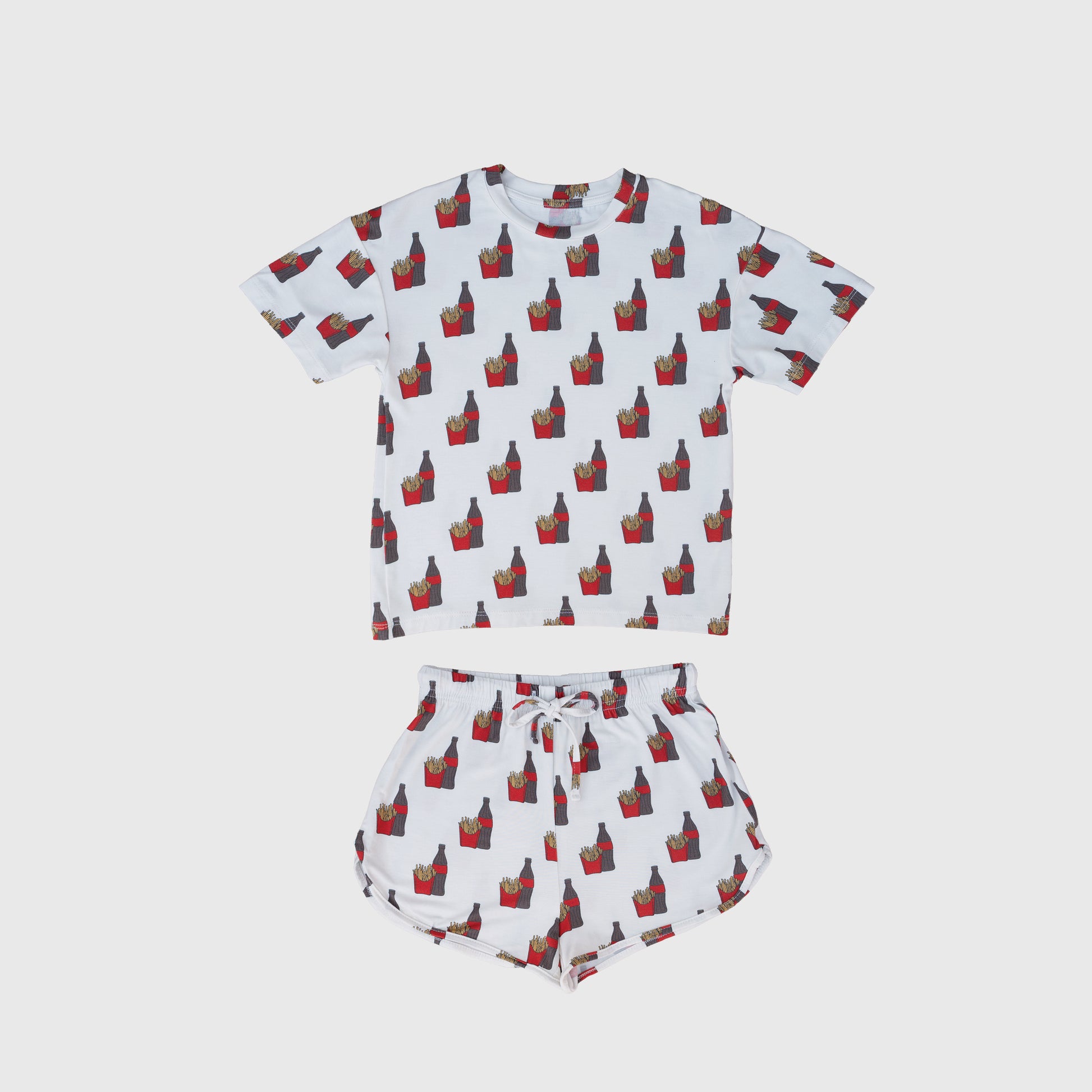 The Girl's Bamboo Short Set | Fries & Cola by forever french baby features a white short-sleeve shirt and shorts with red and yellow French fry cartons, made from hypo-allergenic, breathable bamboo for all-night comfort.