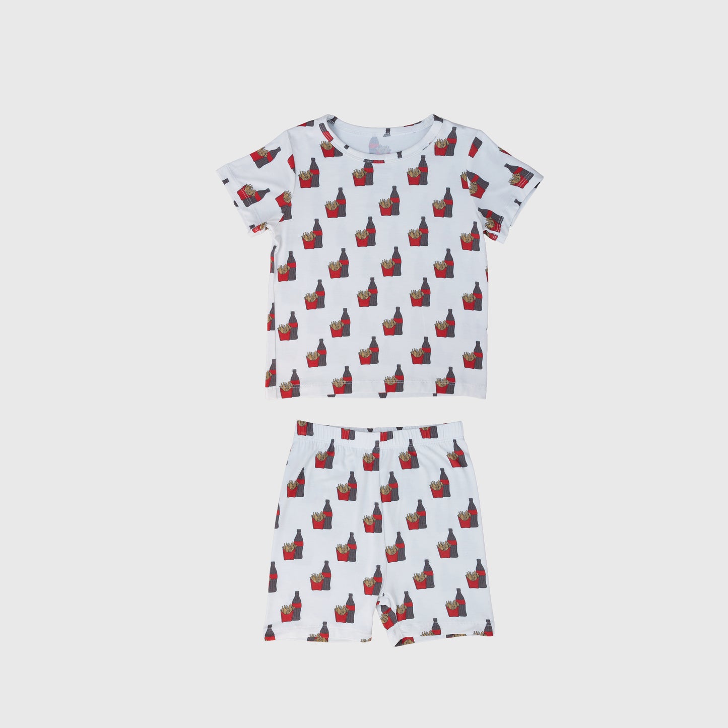 The forever french baby Bamboo Short Set | Fries & Cola features a matching short-sleeve pajama set with playful fries and cola prints on a white background. This breathable set includes a comfy tee and shorts, perfect for cozy nights.