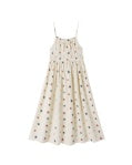 The Delia Dress | Stars by Rylee + Cru is a sleeveless, cream-colored sundress with thin straps and a gathered waist, featuring a playful pattern of small, colorful stars scattered across the fabric.