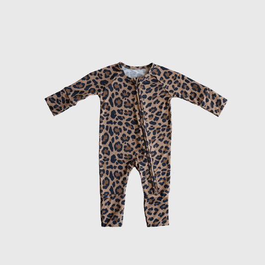 The Bamboo Zip Pajamas | Leopard by forever french baby are long-sleeve, long-leg baby pajamas in a brown and black leopard print, made from breathable fabric with a diagonal zipper. They're shown laid flat on a plain white background.