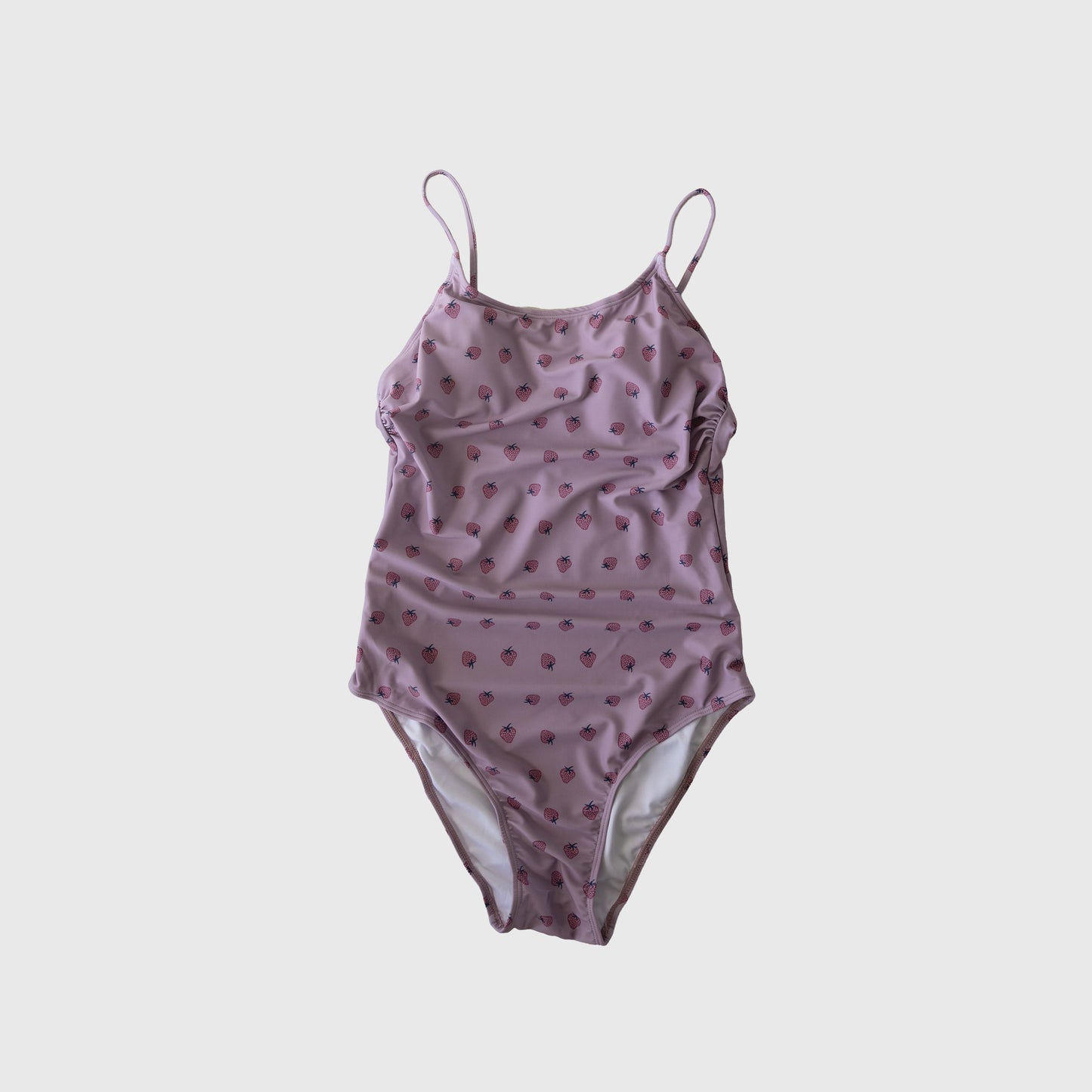 The Women's One Piece Swimsuit | Matilda by Forever French features a light purple design with thin straps and red strawberry prints, shown on a white background—ideal for matching family swimsuits this summer.