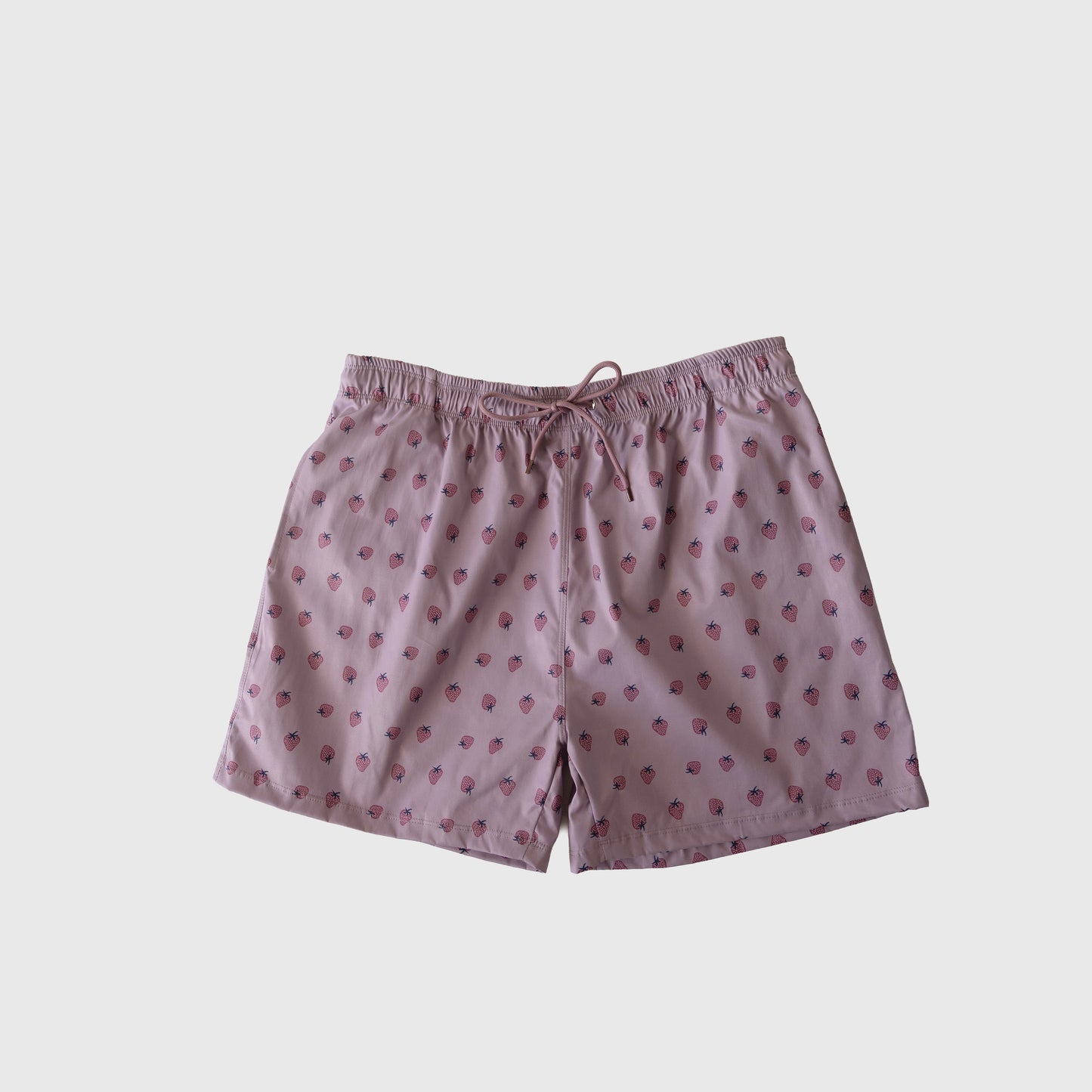 Men's Board Short | Matilda by forever french baby in light pink with playful strawberry print, elastic waistband, and drawstring. Shown on a plain white background. Ideal to pair with the matching swim collection.