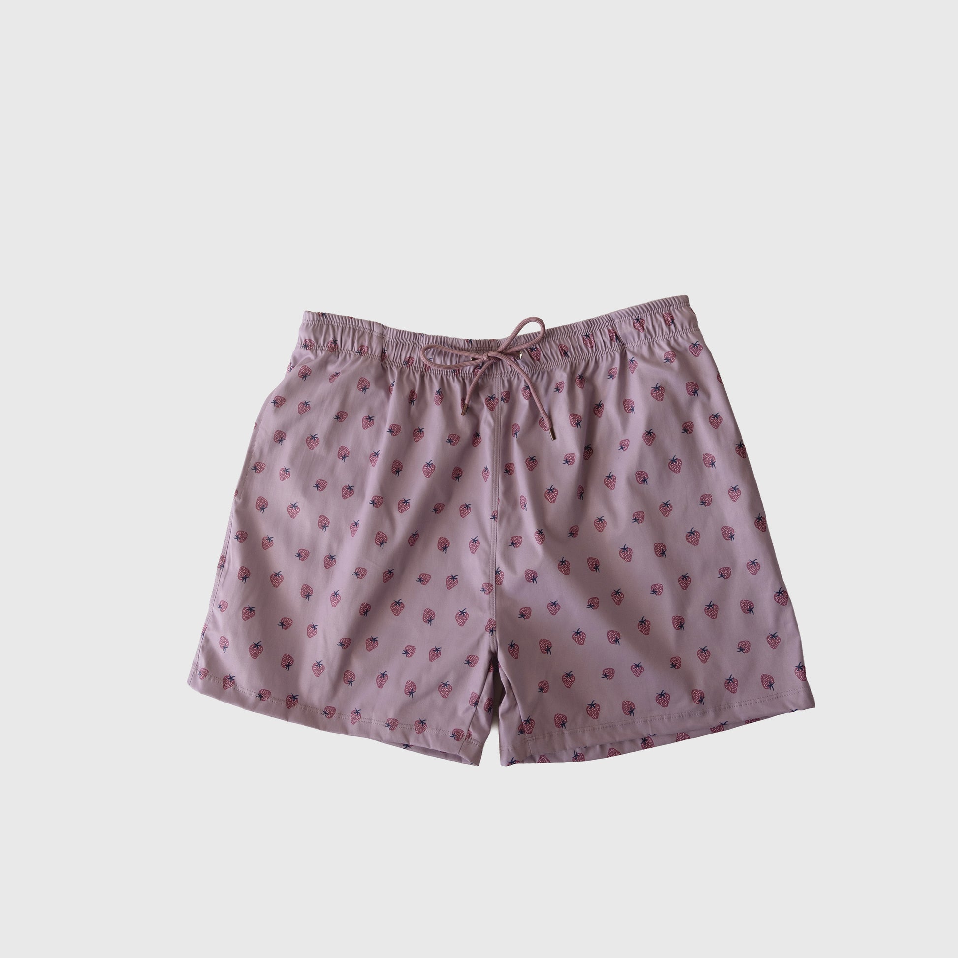 Men's Board Short | Matilda by forever french baby in light pink with playful strawberry print, elastic waistband, and drawstring. Shown on a plain white background. Ideal to pair with the matching swim collection.
