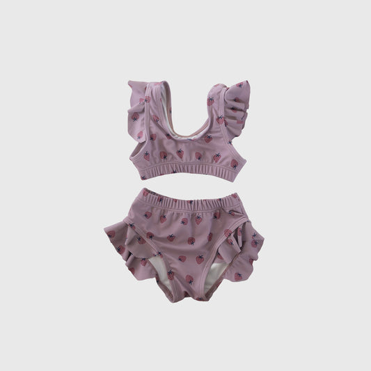 Girl's Two Piece Swimsuit | Matilda by forever french baby: pink strawberry print kids swimwear with ruffled shoulder straps and leg openings, shown on a plain white background.
