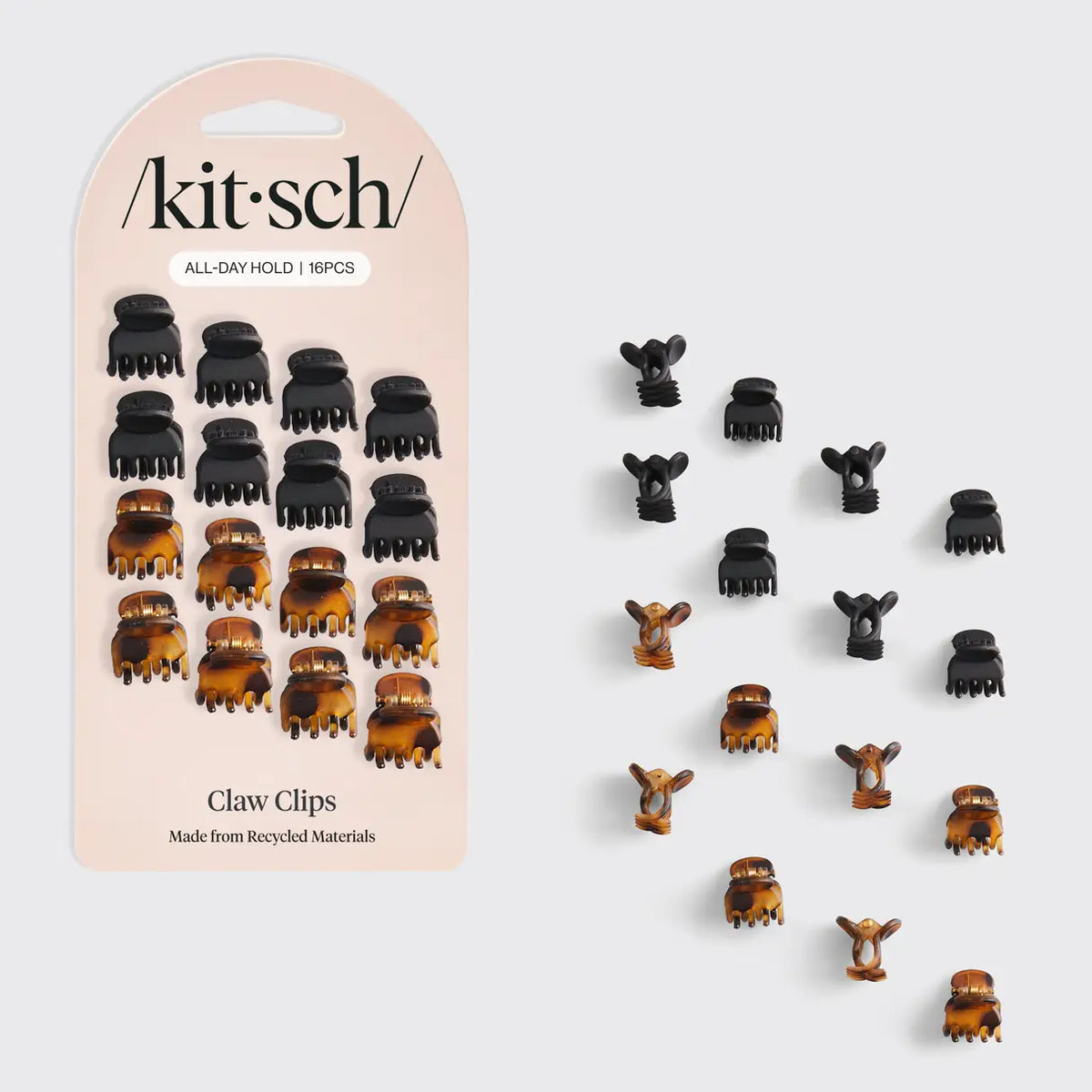 A package of sixteen Micro Classic Claw Clips in black and tortoiseshell, with an additional sixteen loose clips arranged to the right.