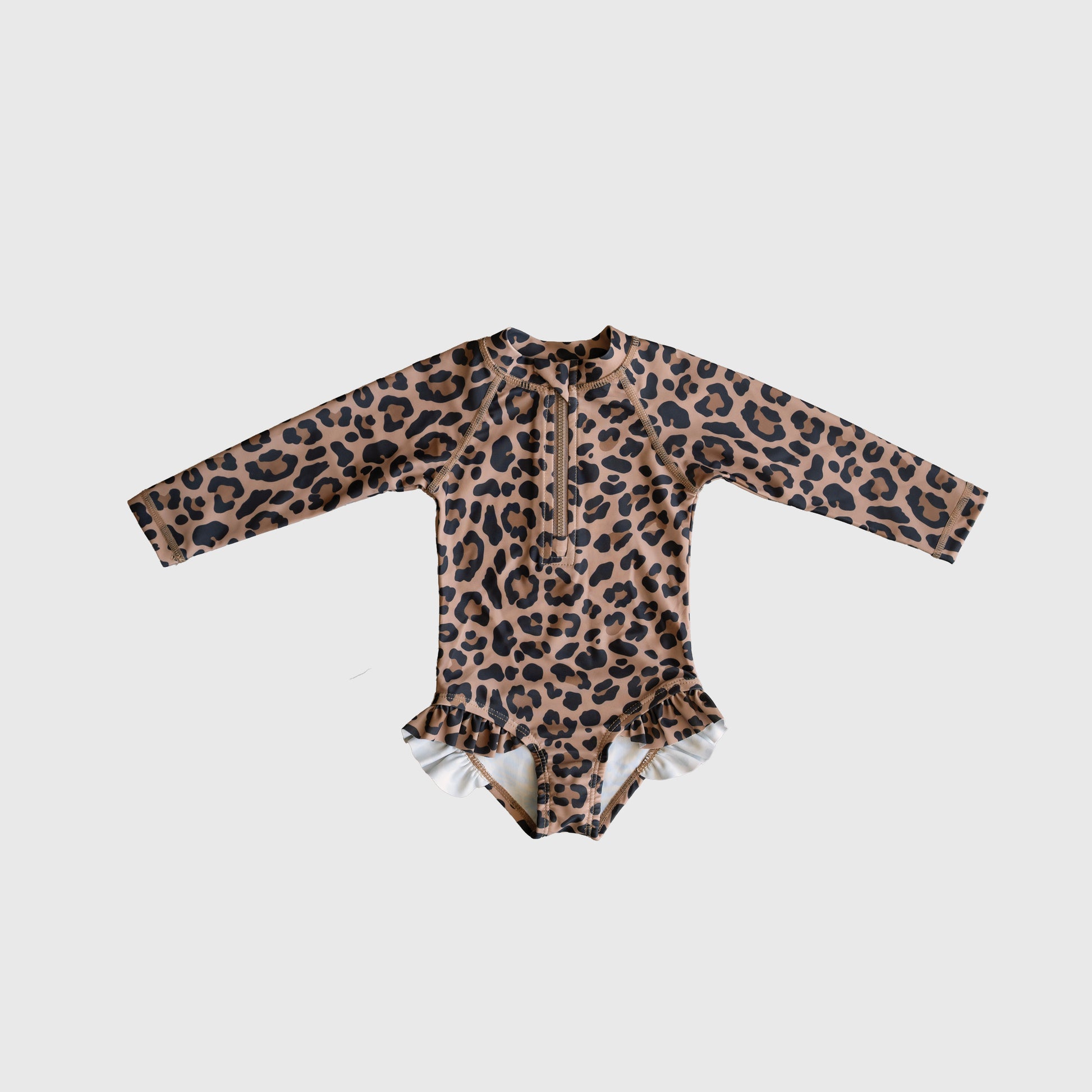 The forever french baby *PRE-ORDER* Girl's Long Sleeve Swimsuit | Leopard features brown and black leopard print with ruffle hip details, shown on a plain white background.