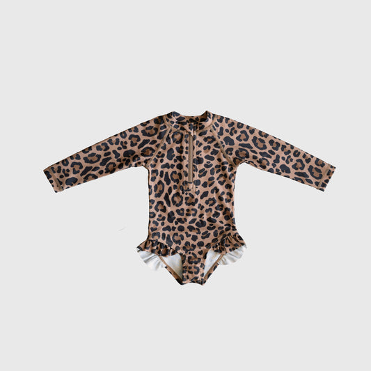 The forever french baby *PRE-ORDER* Girl's Long Sleeve Swimsuit | Leopard features brown and black leopard print with ruffle hip details, shown on a plain white background.