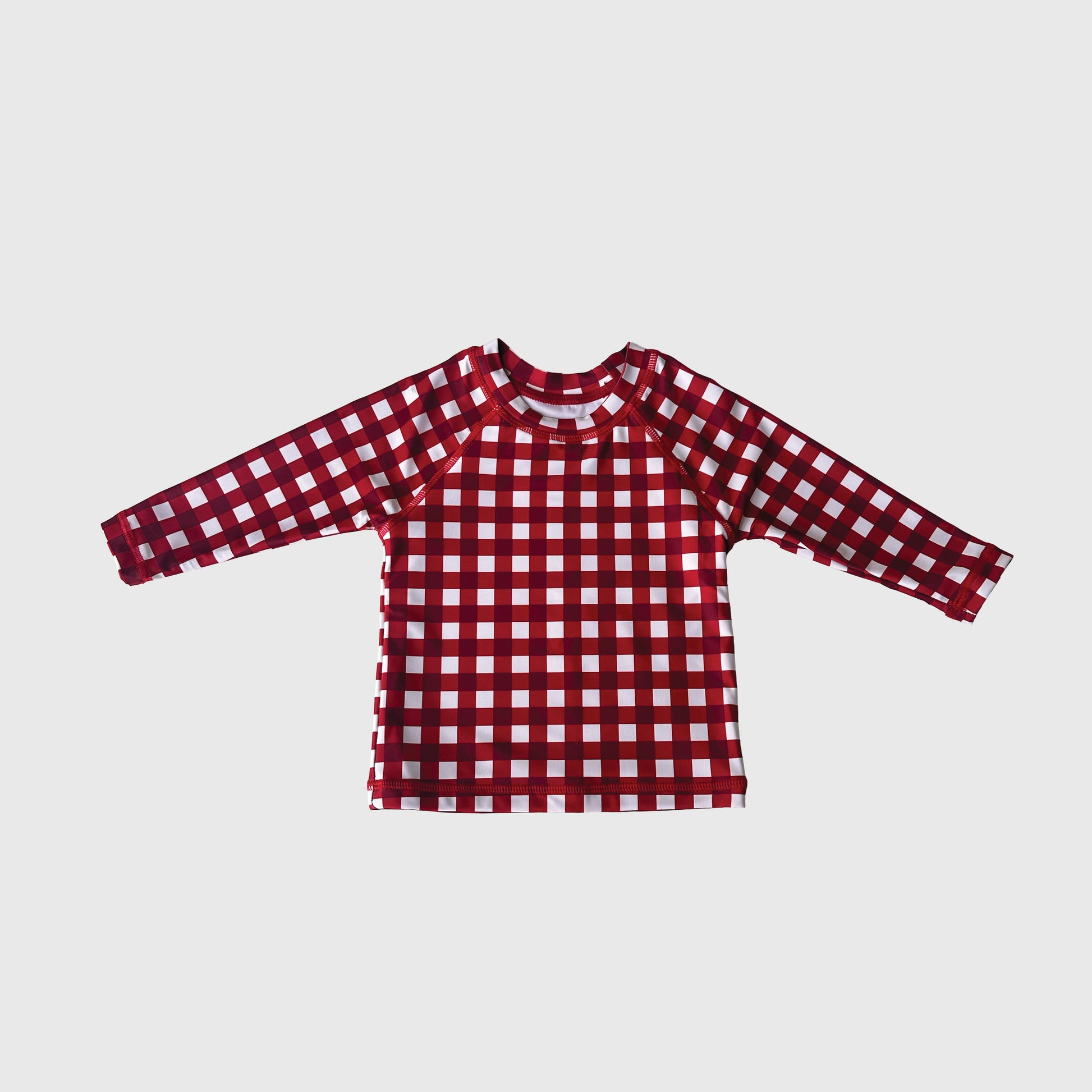The Child Rash Guard in scarlet gingham by forever french baby is shown on a plain light gray background.