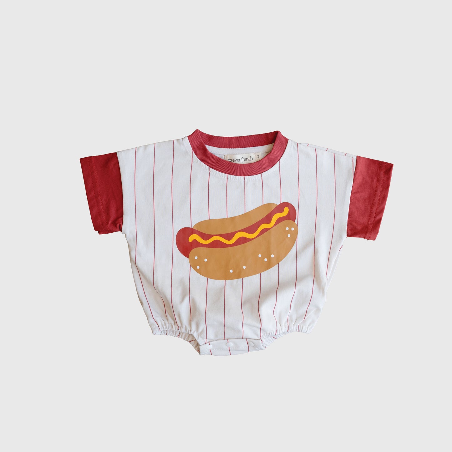 The Short Sleeve Romper | Hot Dog by forever french baby is perfect for family matching, featuring red sleeves, a white body with red stripes, and a playful hot dog graphic on the front.