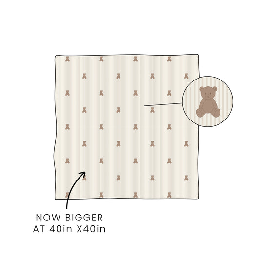 The forever french baby Bamboo Swaddle | Teddy now comes in a larger 40in x 40in size. An inset circle spotlights the teddy bear pattern, with an arrow pointing to the swaddle and text reading "NOW BIGGER AT 40in X 40in.
