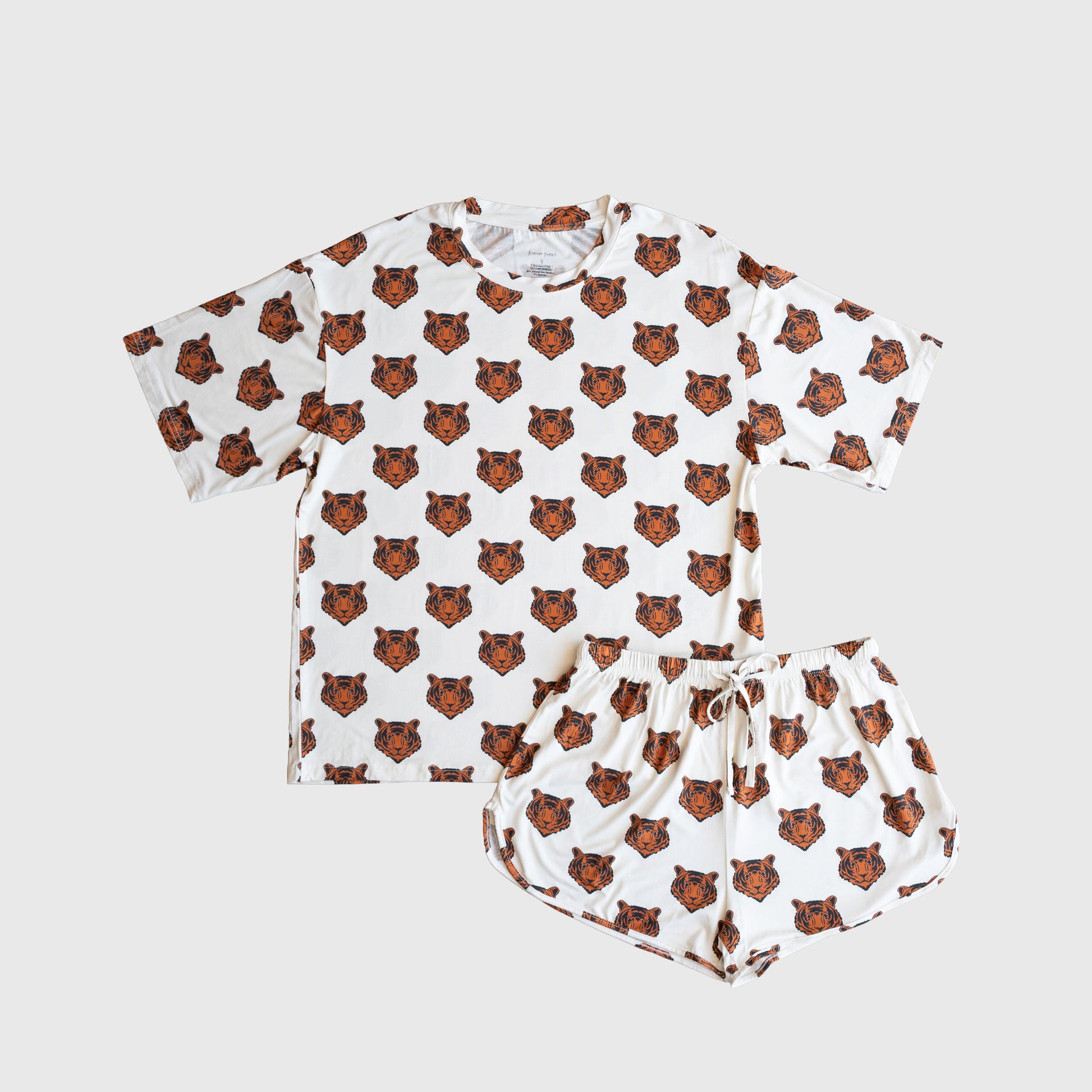 The Women's Bamboo Short Set | Tigers by forever french baby includes a white T-shirt and shorts with an all-over cartoon tiger print, made from breathable bamboo fabric for all-night comfort.