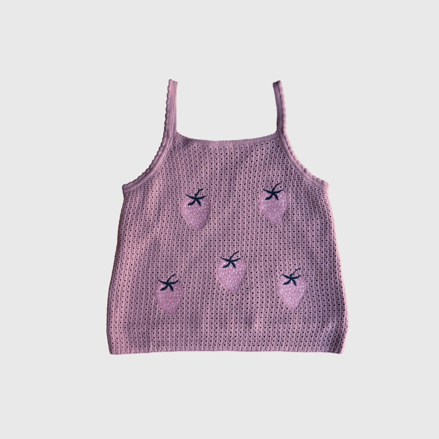 The Women's Knit Short Set | Matilda by forever french baby features a pink knitted tank top with thin straps, made from soft knit fabric and adorned with embroidered strawberries and small dark blue bows, shown against a plain white background.