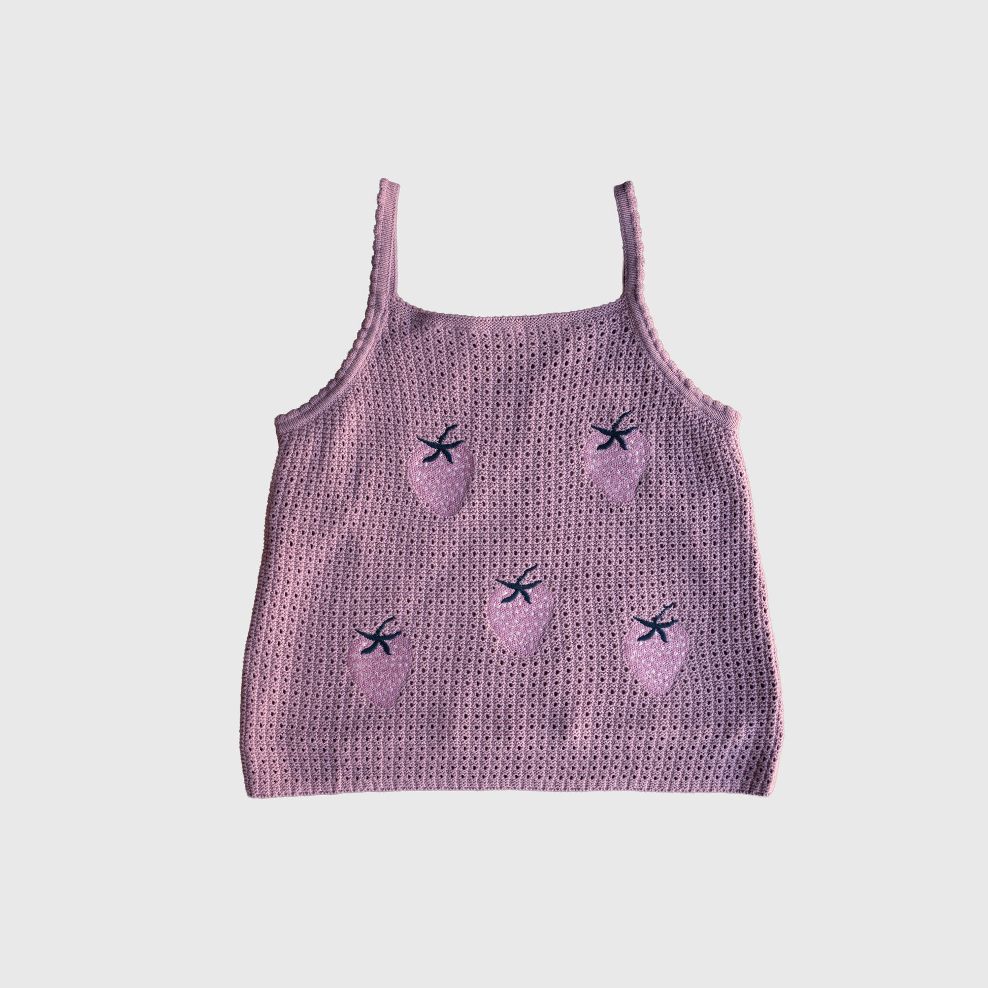 The Women's Knit Short Set | Matilda by forever french baby features a pink knitted tank top with thin straps, made from soft knit fabric and adorned with embroidered strawberries and small dark blue bows, shown against a plain white background.