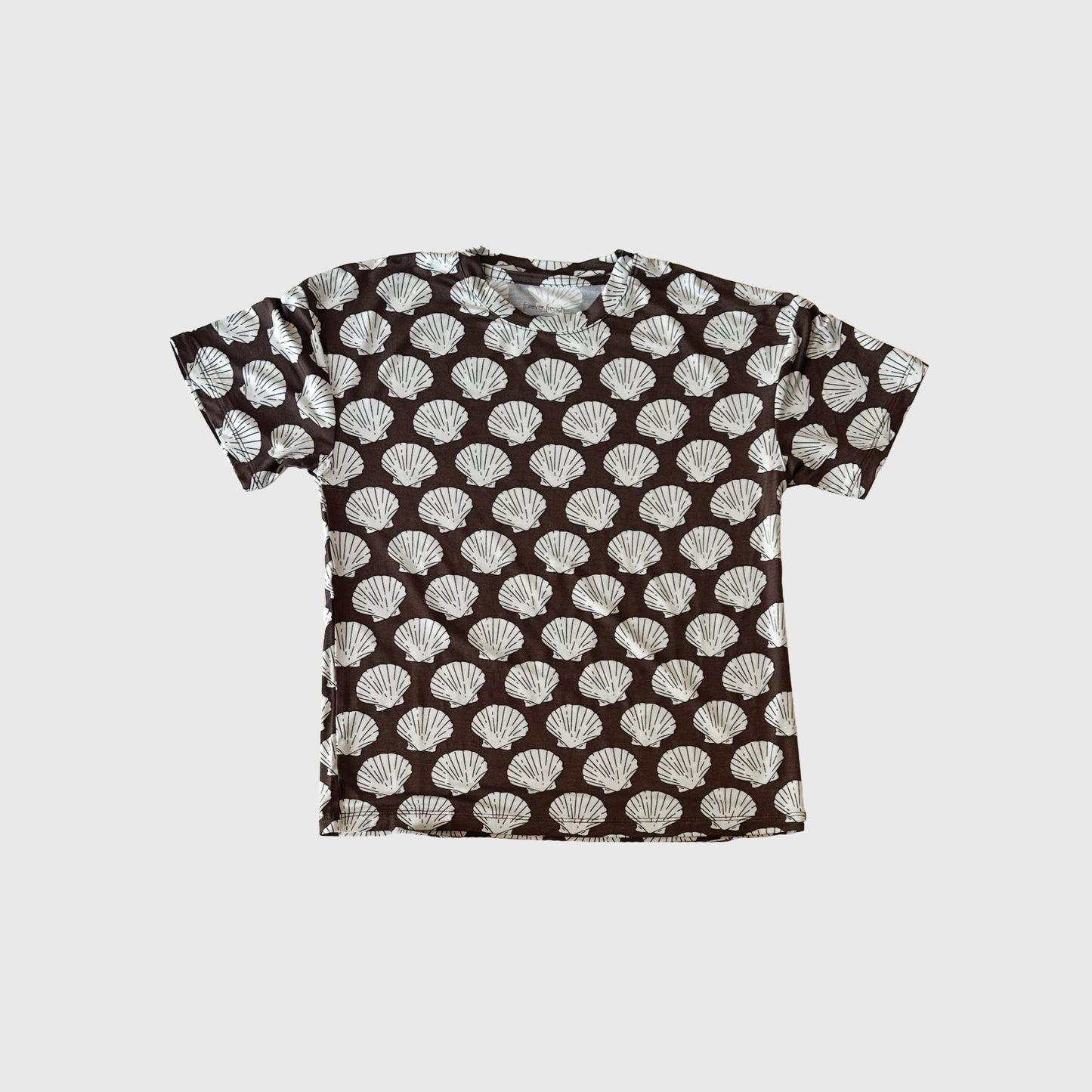 The forever french baby Girl's Bamboo Short Set in the Seashells pattern features a breathable, short-sleeve black top with repeating white shells, showcased against a simple light background.