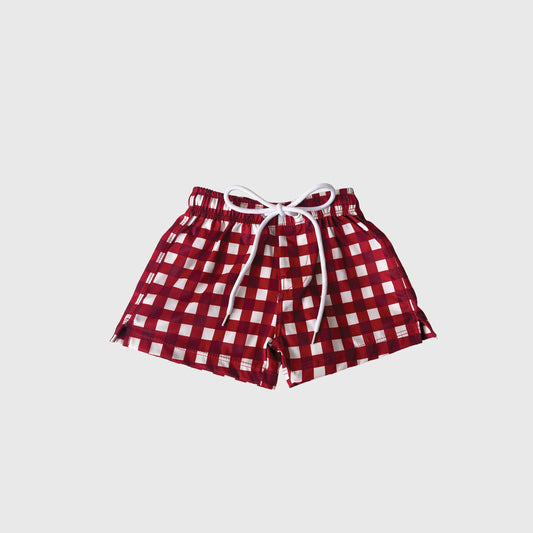 The forever french baby Child Board Short | Scarlet Gingham features a red and white checkered pattern, elastic waistband, and white drawstring—ideal for family matching—all set against a plain white background.