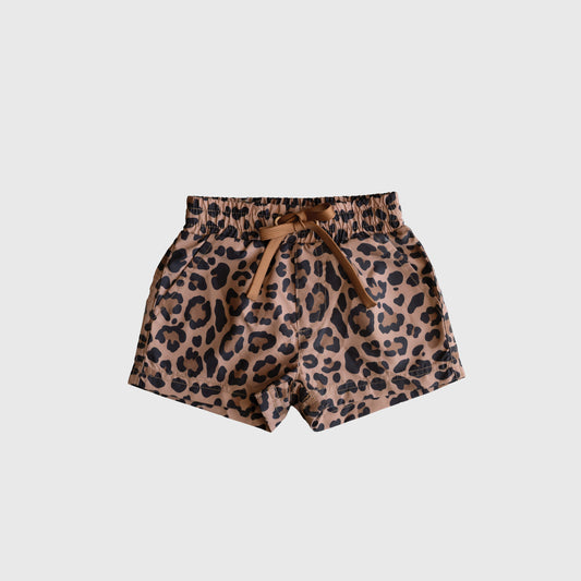 The *PRE-ORDER* Child Board Short | Leopard by forever french baby features a stylish brown leopard print, elastic waistband, and front tie bow—perfect for warm days. Shown on a plain white background.