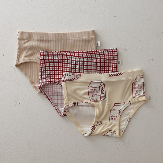 Three pairs of forever french baby Girl's Bamboo Briefs—Window Pane, Milk, and Ribbed Cream—are shown flat, each made from soft hypo-allergenic bamboo.