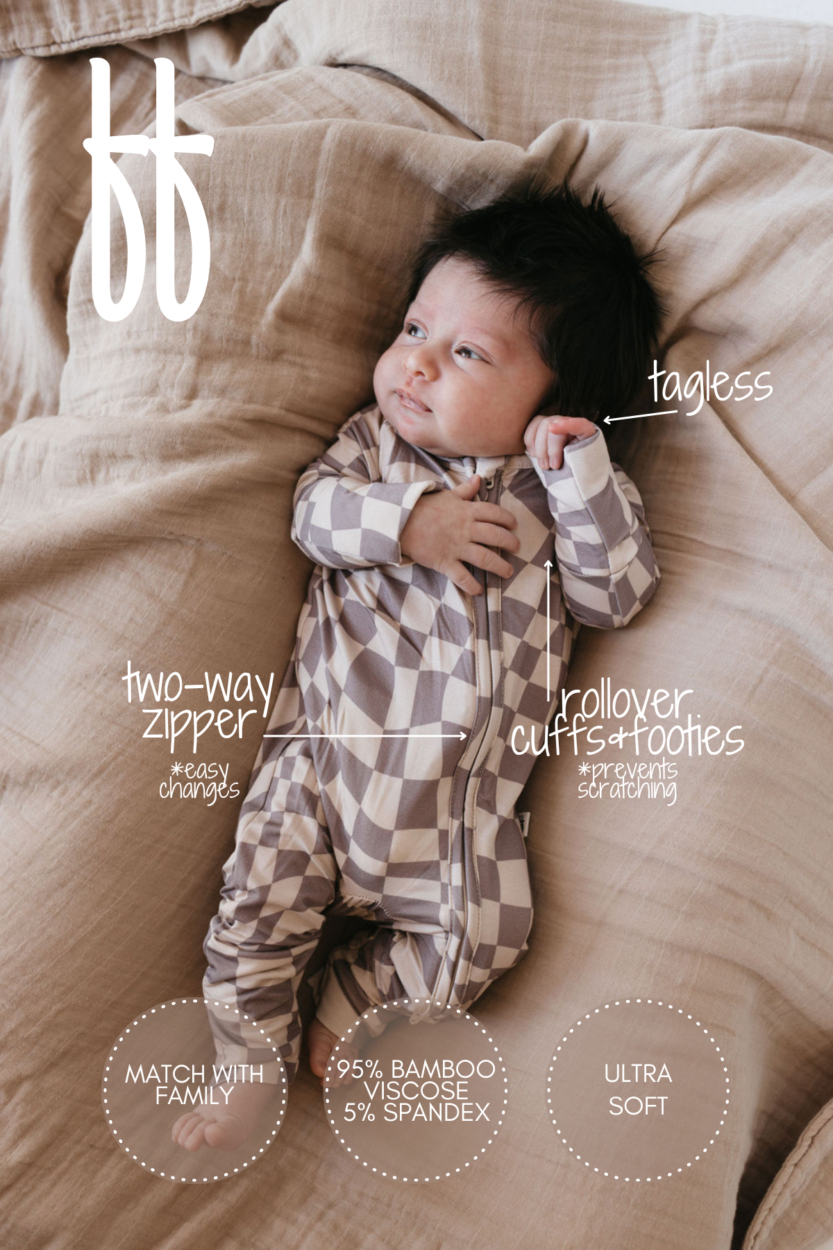 A baby lies on a bed wearing the Smokey Wave Bamboo Zip Pajamas by forever french baby. The pajamas feature a tagless design with a two-way zipper, rollover cuffs, and footies. Made from 95% bamboo viscose and 5% spandex, these hypo-allergenic pajamas offer ultra softness and ease when changing.