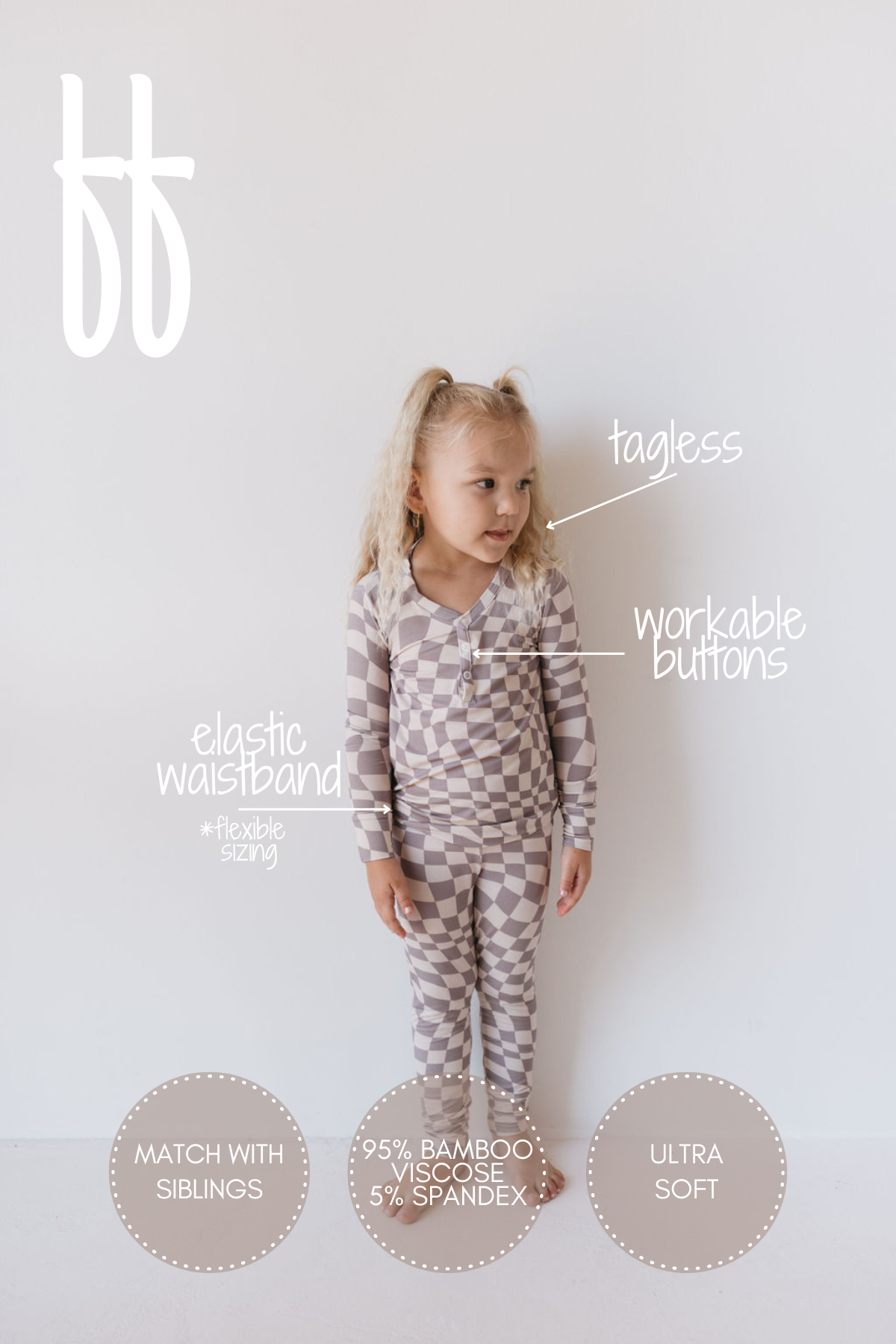 A little girl wearing the "Bamboo Two Piece Pajamas | Smokey Wave" by forever french baby stands against a plain white background. This sleepwear features an elastic waistband, tagless design, functional buttons, and is made from a fabric blend of 95% bamboo viscose and 5% spandex. These ultra-soft, breathable pajamas are perfect for coordinating with siblings.