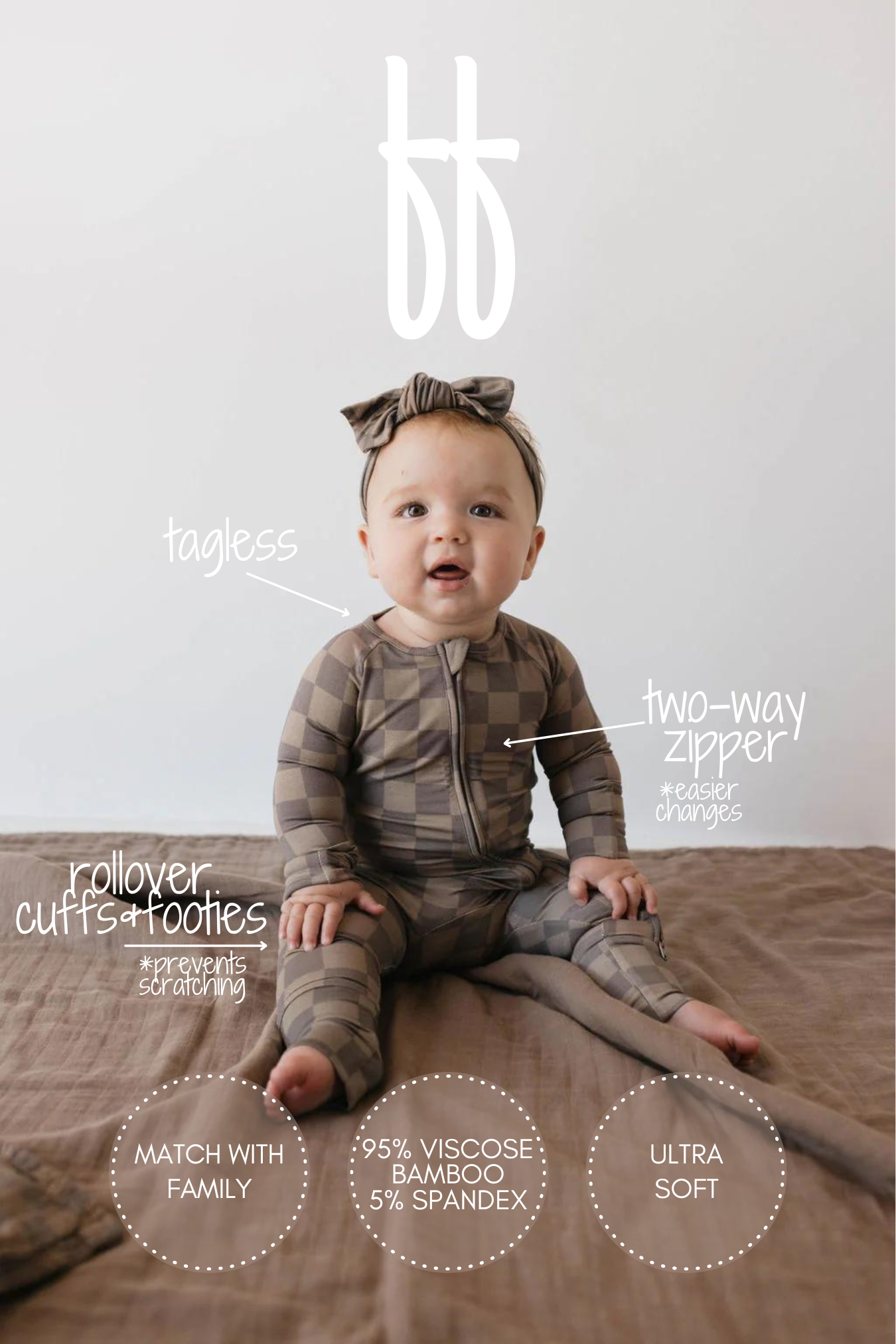 A baby wearing the "Bamboo Zip Pajamas | Faded Brown Checkerboard" from forever french baby sits on a bed. Crafted from breathable bamboo fabric, the onesie features a two-way zipper, rollover cuffs and booties, and is tagless. Text around the baby highlights the hypo-allergenic fabric: it is 95% viscose from bamboo, 5% spandex, ultra-soft, and perfect for family matching.