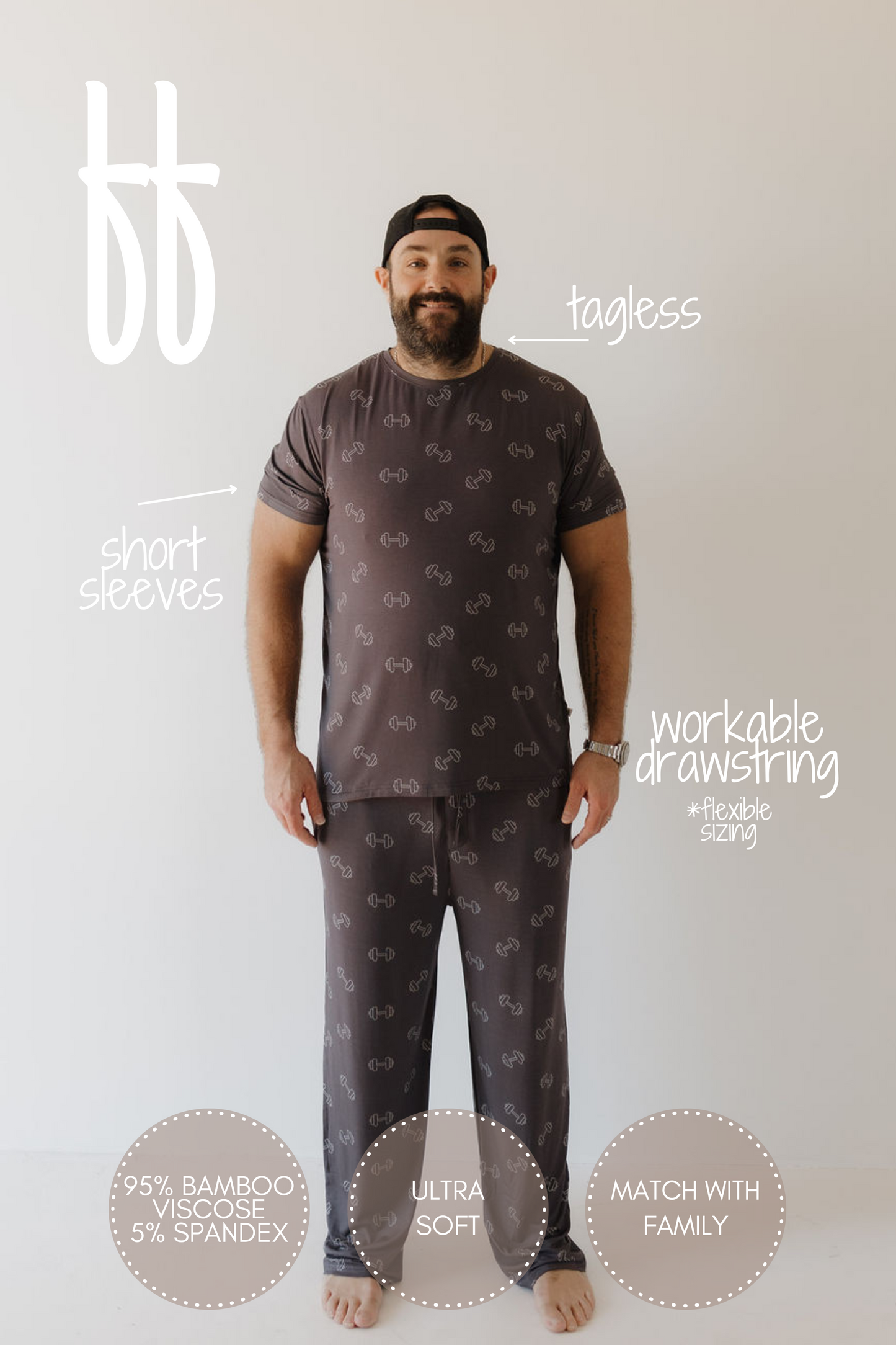 A man models the "Bamboo Men's Short Sleeve Pajama | Charcoal Arm Day" by forever french baby against a white backdrop. The tagless, short-sleeved shirt is subtly patterned; the pants have a workable drawstring and are made of hypo-allergenic 95% bamboo viscose and 5% spandex.