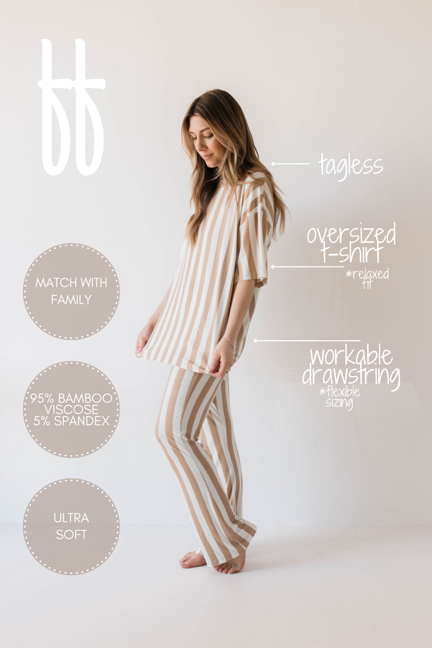 A woman wearing the forever french baby Short Sleeve Women's Bamboo Pajamas in the Kal Stripe pattern stands in front of a light wall, enjoying her hypo-allergenic clothing. The matching oversized pajama set consists of an oversized t-shirt and pants, with garment details including "tagless," "match with family," "workable drawstring," "95% bamboo viscose, 5% spandex," "relaxed fit,” and "ultra-soft.