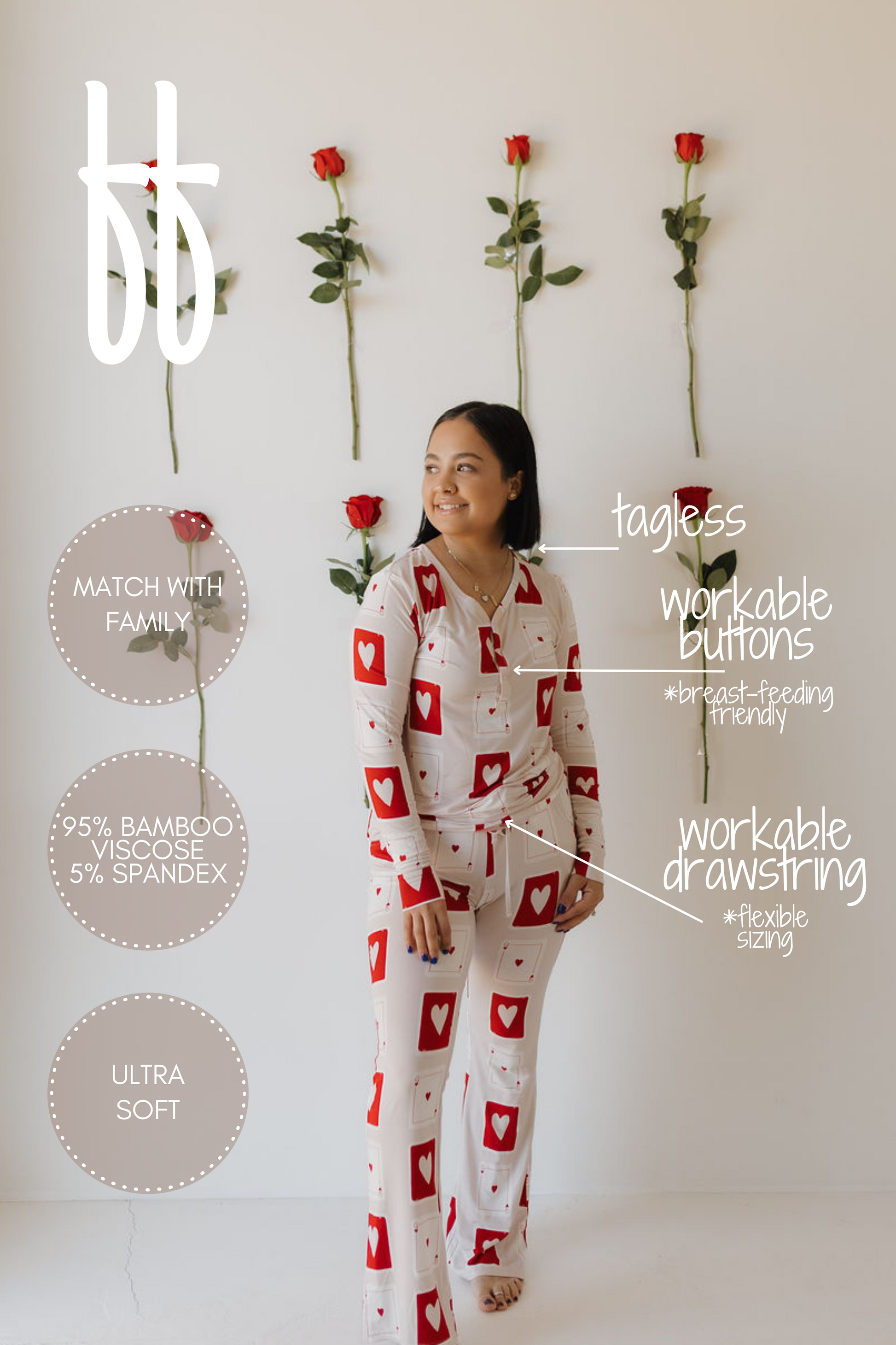 A woman in heart-patterned Women's Bamboo Pajamas by forever french baby stands before a rose-accented white wall. These ultra-soft, hypo-allergenic pajamas are 95% bamboo viscose and 5% spandex, featuring tagless design, workable buttons, breastfeeding-friendliness, drawstring waist, and family match option.