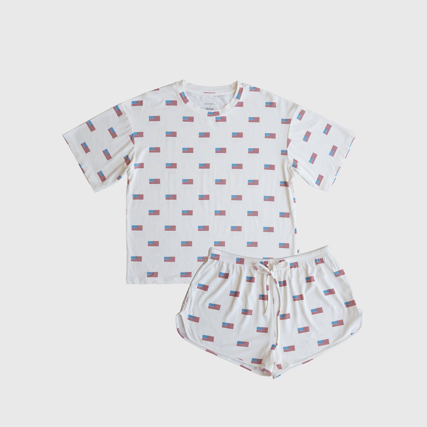 The forever french baby Women's Bamboo Short Set | Americana Ribbed features a hypoallergenic white T-shirt and shorts with red, blue, and white rectangle patterns, laid flat on a plain white background for a clean, stylish look.