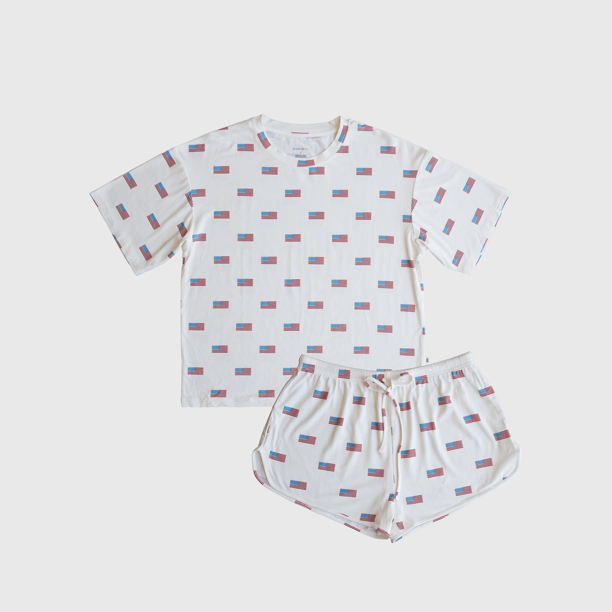 The forever french baby Women's Bamboo Short Set | Americana Ribbed features a hypoallergenic white T-shirt and shorts with red, blue, and white rectangle patterns, laid flat on a plain white background for a clean, stylish look.