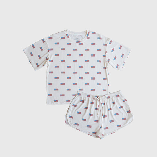 The forever french baby Women's Bamboo Short Set | Americana Ribbed features a hypoallergenic white T-shirt and shorts with red, blue, and white rectangle patterns, laid flat on a plain white background for a clean, stylish look.