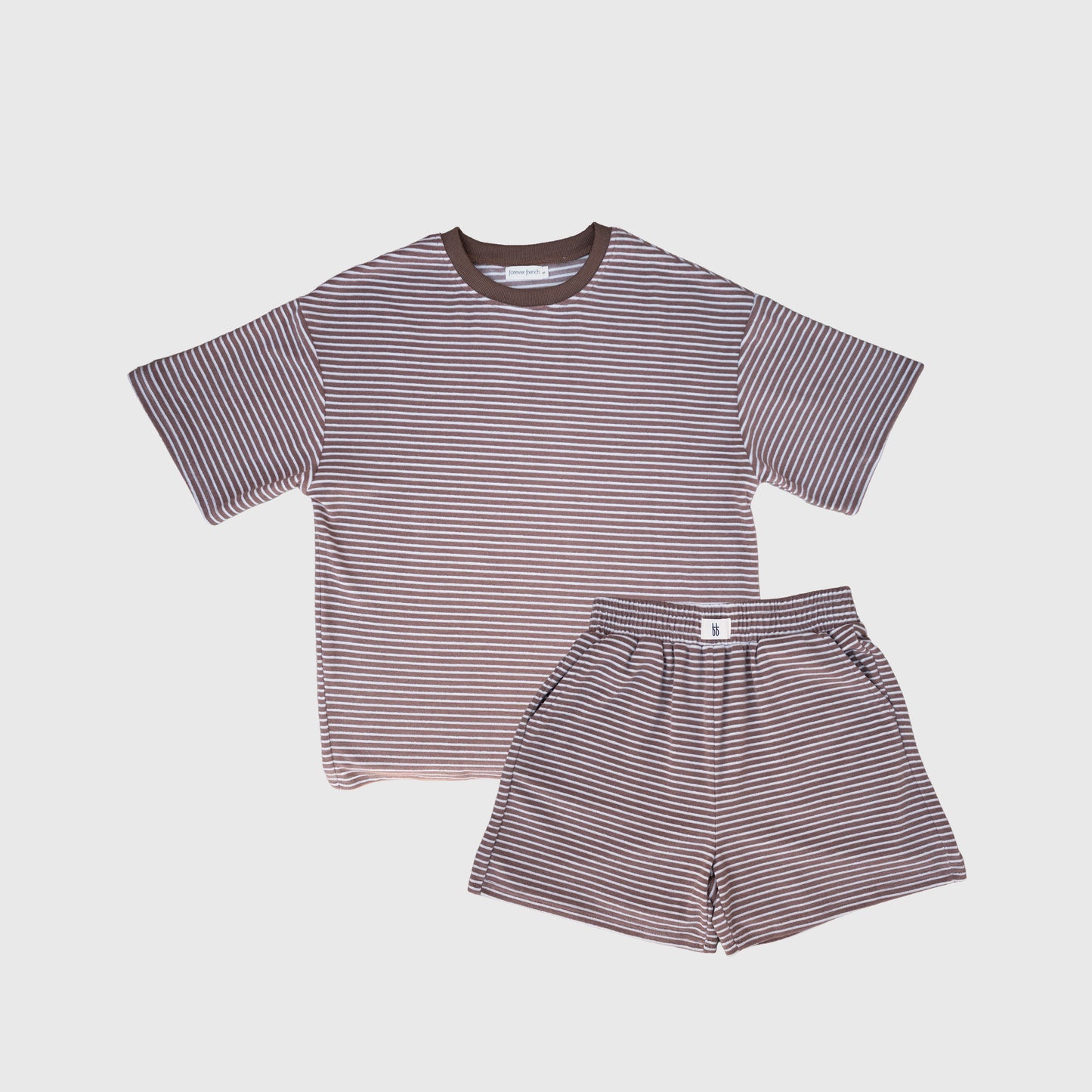 The forever french baby Women's Terry Short Set | Cola Stripe features a matching short-sleeve tee and shorts with thin brown and white stripes, ideal for loungewear. Shown on a plain white background.